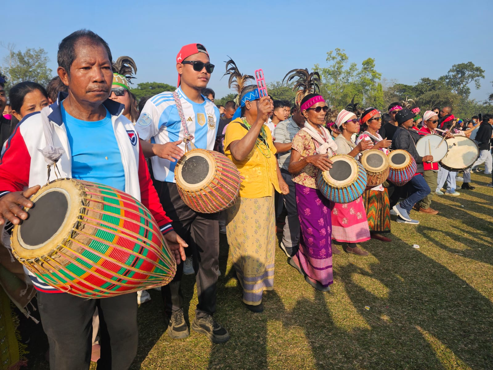 A massive celebration marked the Garo New Year 2026, bringing together thousands of people from across India and even international visitors to the Bangsi Apal playground in North Garo Hills. The festival showcased the rich cultural heritage of the Garo community and was especially notable for its vibrant drumming and traditional dances.  The festivities began early in the morning around 9 AM, as the first beats of the drums echoed through the area, drawing crowds eager to join the celebration. Women, taking center stage, played powerful drum rhythms that energized the participants. Men, women, and young people danced together to the pulsating beats, creating a lively and colorful atmosphere.  By noon, hundreds of thousands of people were seen dancing and celebrating in unison, marking one of the largest gatherings for the Garo New Year in recent years. The event not only highlighted the community’s artistic traditions but also reinforced unity, joy, and cultural pride among participants.  Organizers said the festival aims to preserve tribal customs while providing a platform for cultural exchange, as many visitors from outside the region attended and participated. The 2026 celebration of the Garo New Year was hailed as a grand success, leaving lasting memories for all who attended.